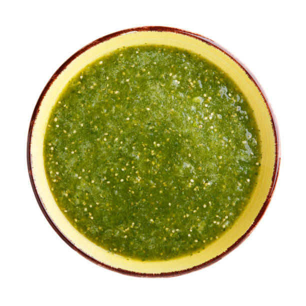 tomatillo salsa verde. bowl of spicy green sauce isolated on white table, mexican cuisine. top view. - molho verde imagens e fotografias de stock