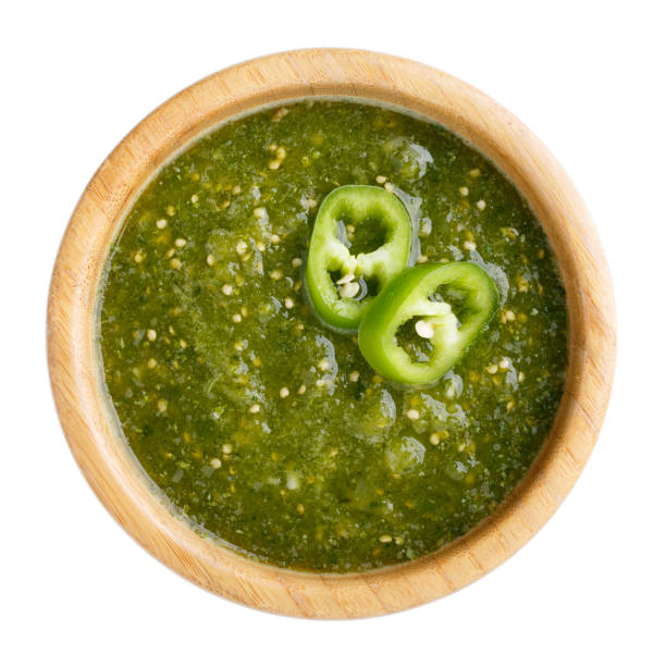 Tomatillo salsa verde. Bowl of spicy green sauce isolated on white table, mexican cuisine. Top view. Tomatillo salsa verde. Bowl of spicy green sauce isolated on white table, mexican cuisine. Top view. tomatillo photos stock pictures, royalty-free photos & images