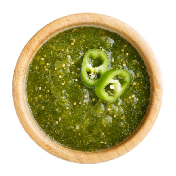 tomatillo salsa verde. bowl of spicy green sauce isolated on white table, mexican cuisine. top view. - molho verde imagens e fotografias de stock