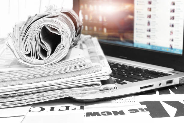 istock Newspapers and Laptop 1181423695