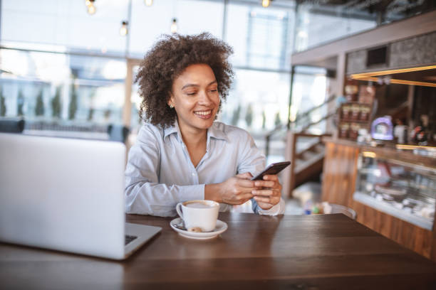 istock Woman with mobile phone at the Cafe bar 1181423721