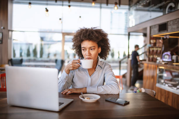 istock Young woman drinking coffee at the Cafe bar 1181424412