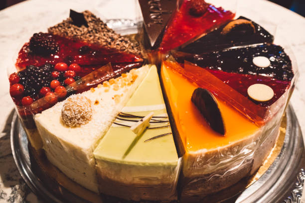 Close-up of decorative dessert squares with pink and green frosting on a glass plate.