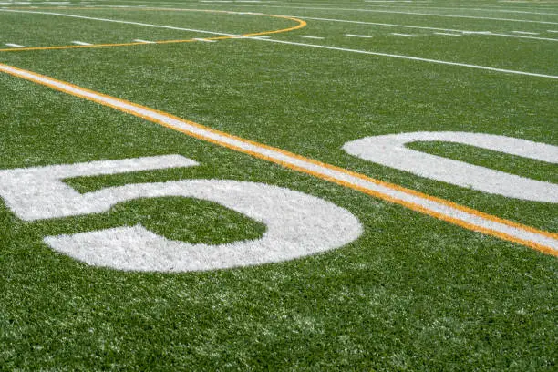 Photo of view of fifty yard line on sideline of football field