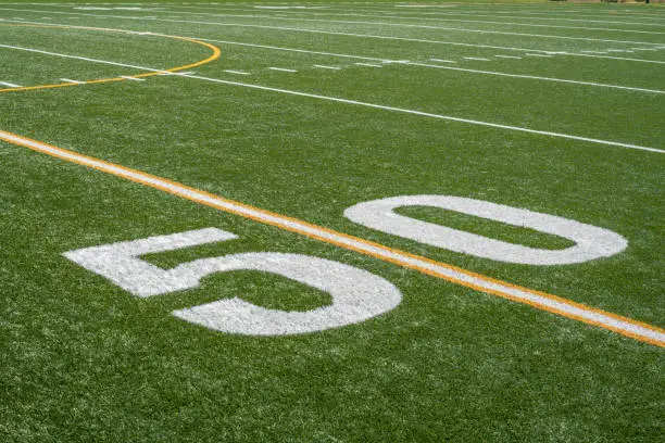 Photo of view of fifty yard line from sideline of football field