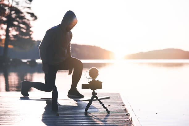 istock Exercise influencer recording a workout video outdoors at dawn 1181428207