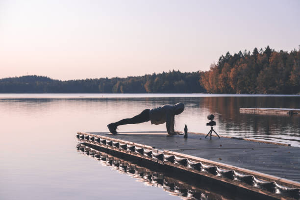 istock Exercise influencer recording a workout video outdoors at dawn 1181428210