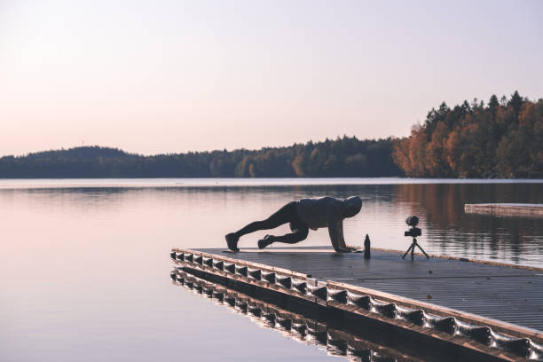 istock Exercise influencer recording a workout video outdoors at dawn 1181428211