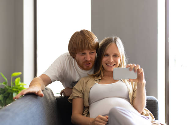 istock Happy expectant parents using cellphone for selfie 1181428274