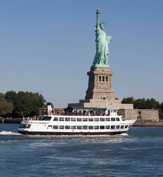 istock Liberty Statue and cruise boat 118142909