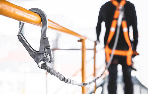istock Construction worker wearing safety harness and safety line working at high place. Working at height equipment. Fall arrestor device for worker with hooks for safety body harness 1181430560