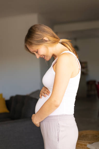 istock Happy expectant mother talking to her baby bump 1181431020