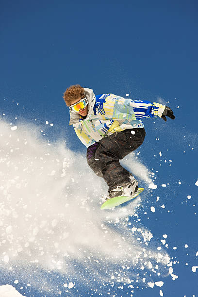 istock Snowboarder In Mid-Air Against Blue Sky 118143183