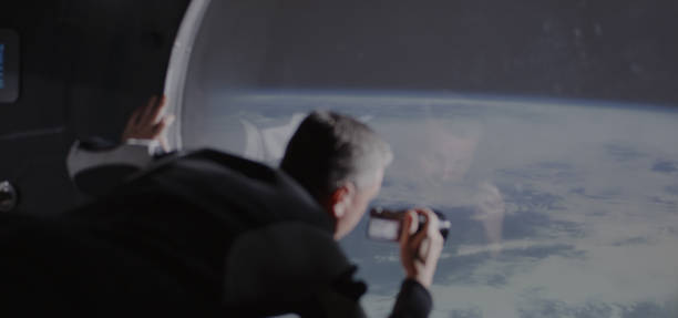 Astronaut filming Earth from spaceship