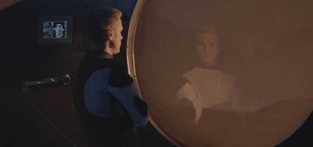 istock Astronaut looking out of window of Mars base 1181431966