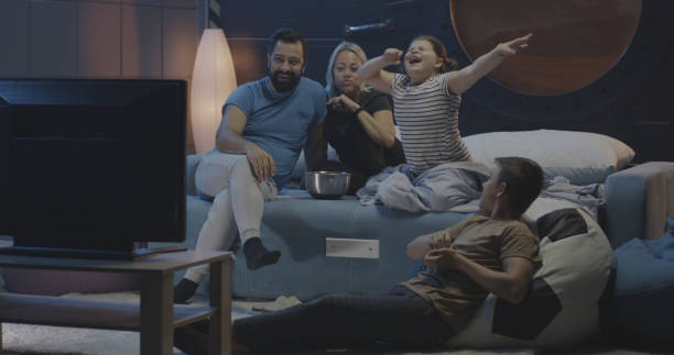 istock Family watching television on Mars 1181432183