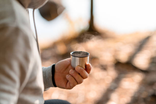 istock Man drinking coffee by the lake after an outdoor exercise 1181433174