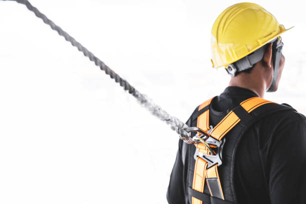 istock Construction worker wearing safety harness and safety line working at high place. Working at height equipment. Fall arrestor device for worker with hooks for safety body harness isolated on white bac 1181435195