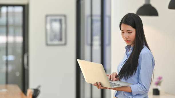 istock Young creative woman working laptop computer in office room. 1181436288