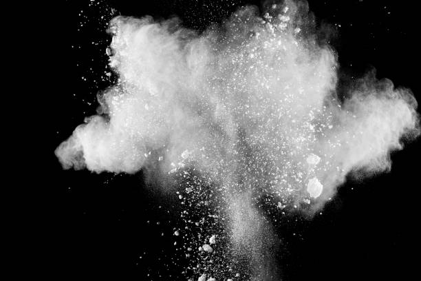 istock Bizarre forms of white powder explosion cloud against black background.White dust particles splash. 1181437135