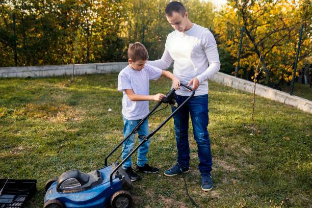 istock Father and son working together in formal garden 1181438909