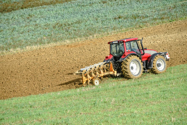 istock beautiful landscape with a farmer plowing his fields 1181439001