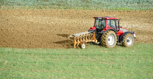 istock beautiful landscape with a farmer plowing his fields 1181439070