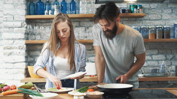 istock Young couple making dinner together at home 1181441953