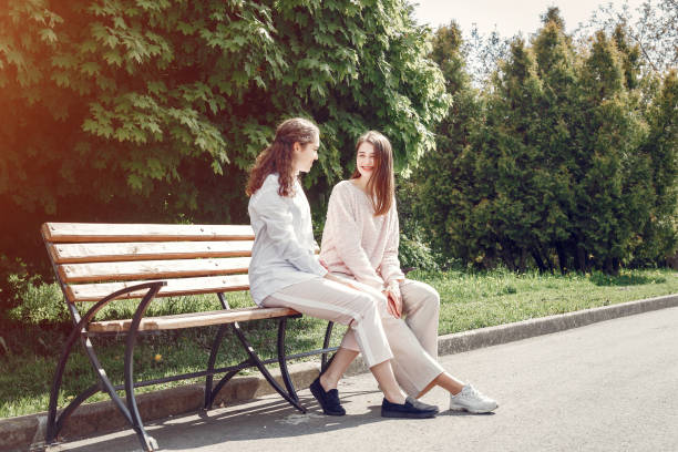 istock Elegant and stylish sisters in a spring park 1181442011