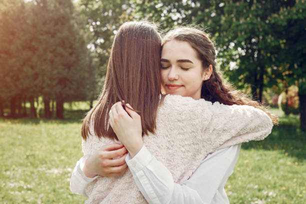 istock Elegant and stylish sisters in a spring park 1181442070