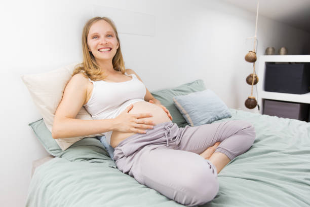 istock Cheerful expectant mother feeling happy at home 1181442774