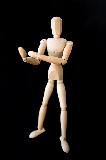 Wooden mannequin showing middle finger