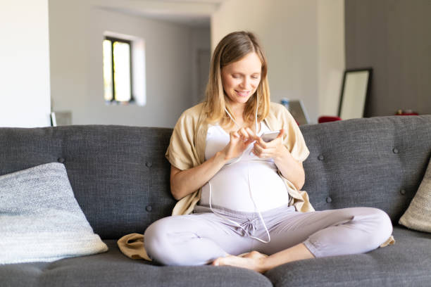 Happy expectant mother watching content