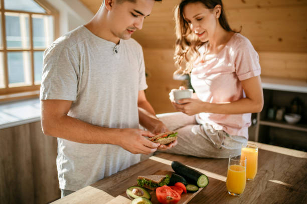 Young cheerful spouses enjoying morning time together
