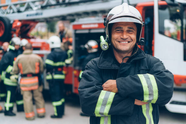 Firefighter's portrait Firefighter looking at camera fire station stock pictures, royalty-free photos & images