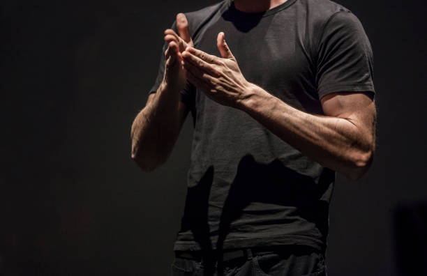 istock Sign language man interpreter gestures over stage during public event 1181447458