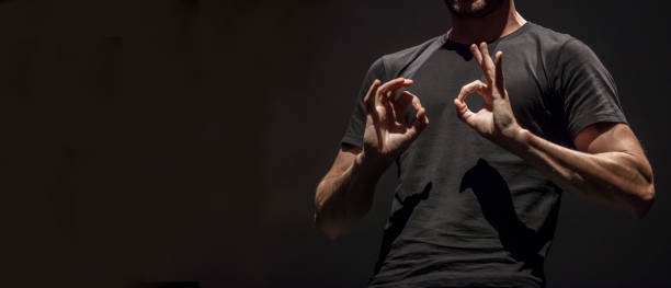 istock Sign language man interpreter gestures over stage during public event 1181447459