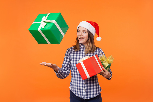 Beautiful emotional woman holding present box