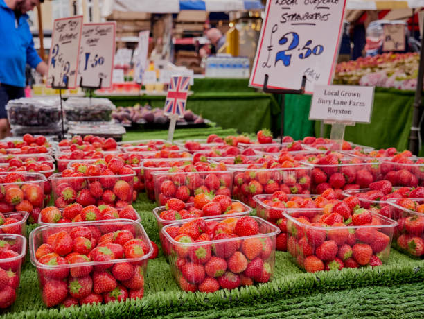 Cambridge, UK - October 9, 2019: Stall with strawberries in plastic boxes in the market