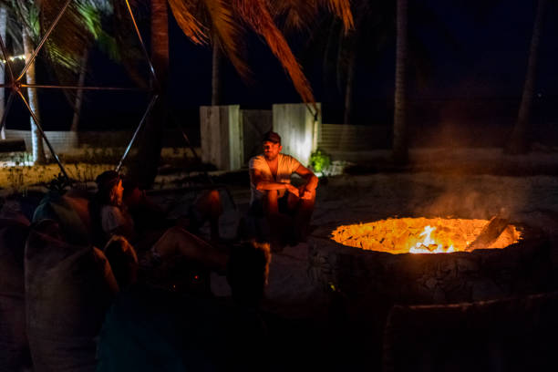 istock Friends sit around fire pit enjoying island life 1181450962