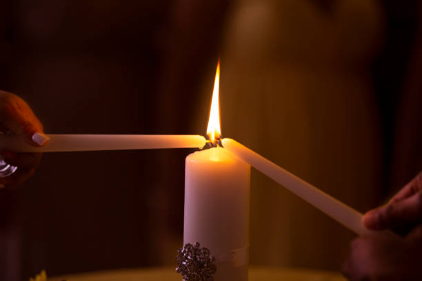 Couple lighting a candle at their wedding.