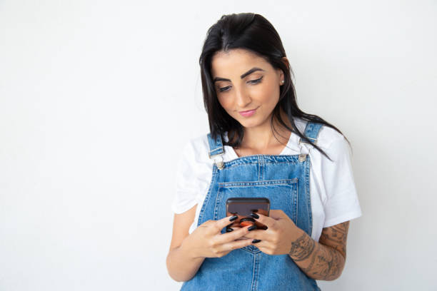 Charming smiling girl holding phone
