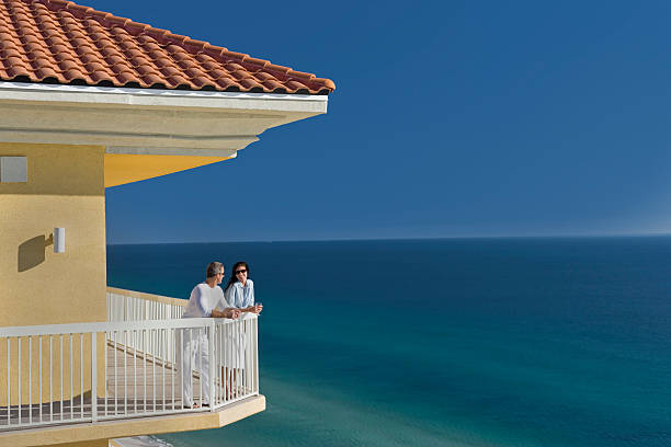 istock Couple Talking On Porch Overlooking Ocean 118145443