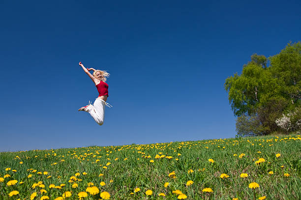 istock young woman in red outfit having fun on meadow 118145491