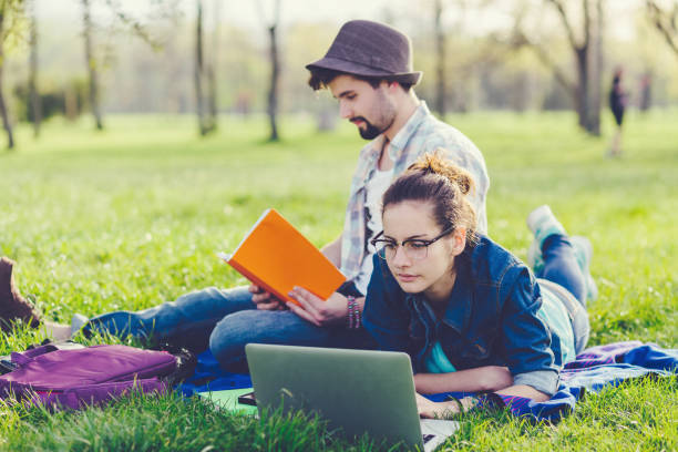 istock Young couple studying in the park 1181455158
