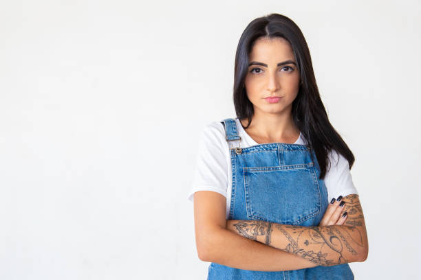 istock Serious young brunette with crossed arms 1181455707