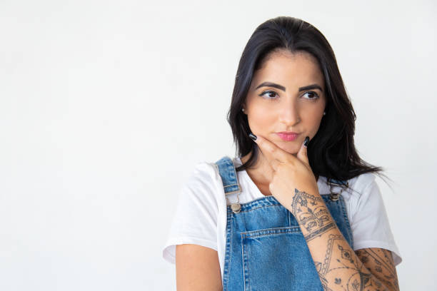 istock Front view of attractive young lady holding hand on chin 1181455827