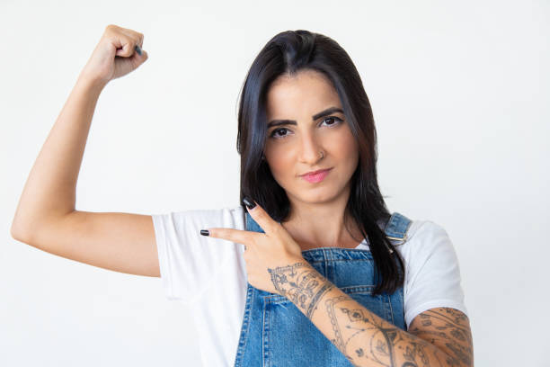 istock Serious young woman pointing at arm 1181456110