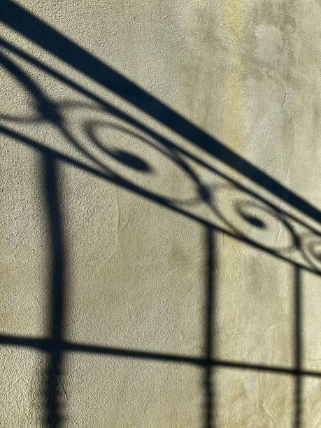 istock shadow of a wrought iron gate 1181456853