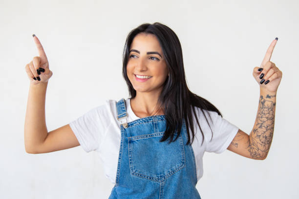 istock Joyful brunette pointing with fingers up 1181456985